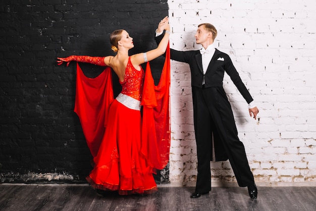 Couple dancing near black and white wall