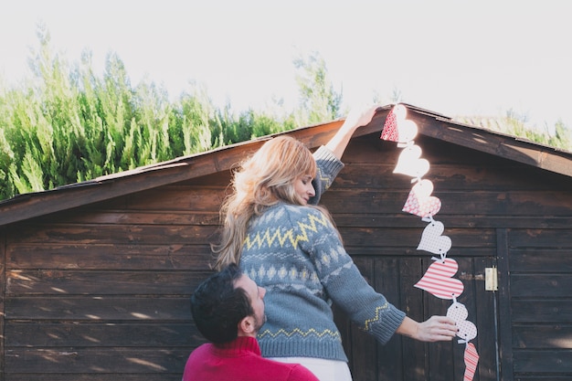 Free Photo couple decorating house with hearts