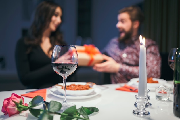 Couple at dinner exchanging with presents