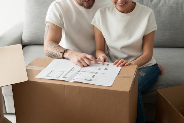 Free photo couple discussing house plan, moving in new home, planning renovation