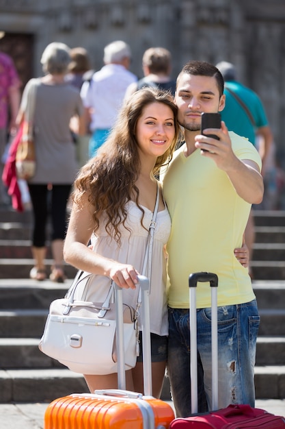 Couple doing selfie at the street