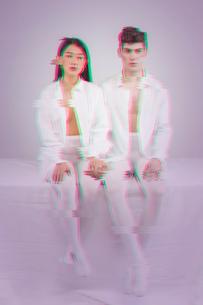 Free photo couple dressed in white clothes with glitch effect