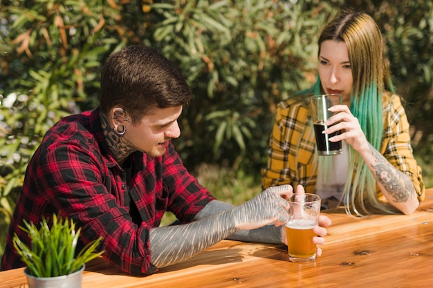 Couple drinking craft beer outdoors