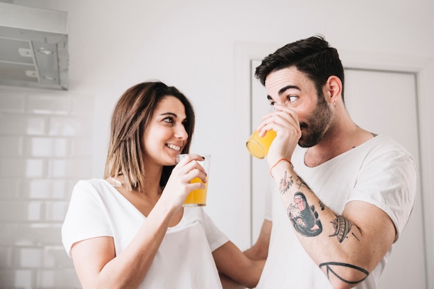 Couple drinking juice in kitchen