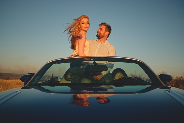 Couple driving in cabriolet car