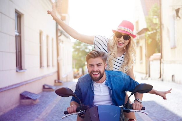 Free Photo couple driving a scooter through the city