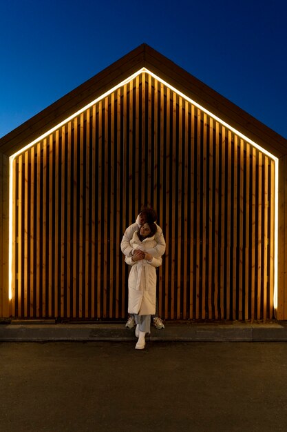 Couple embracing each other while outdoors at night