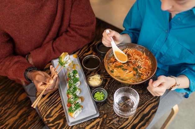 Free photo couple enjoying food in restaurant