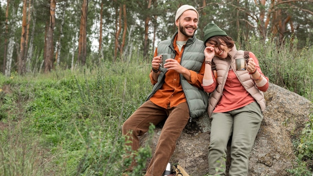 Couple enjoying hot drink in nature