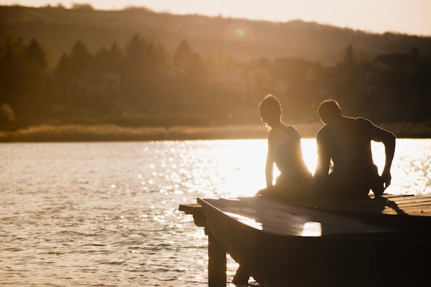 Couple enjoying the sunset on the pier