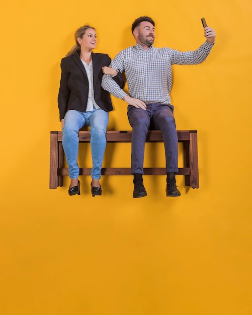 Free Photo couple floating on a bench