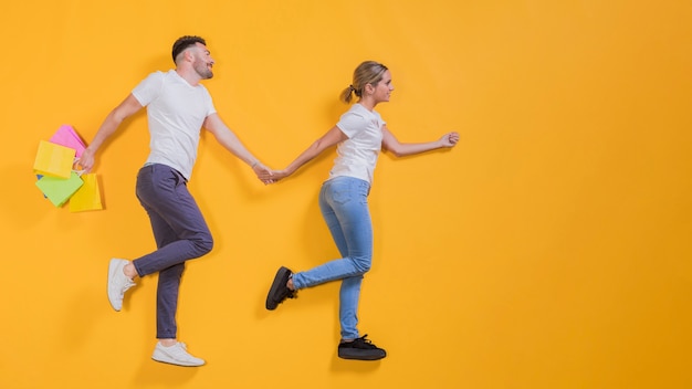 Couple flying with shopping bags