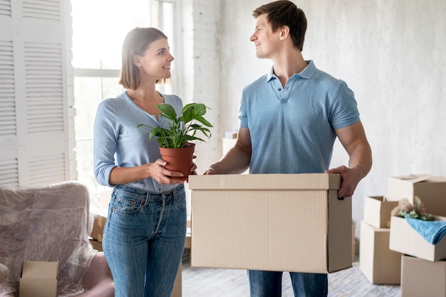 Couple getting things in boxes to move out