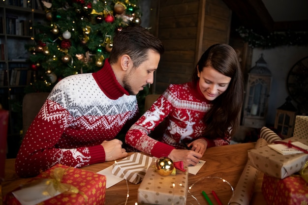 Couple giving each other christmas gifts