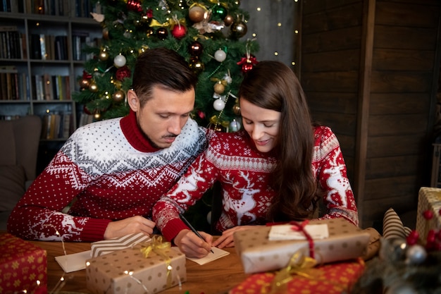 Couple giving each other christmas gifts