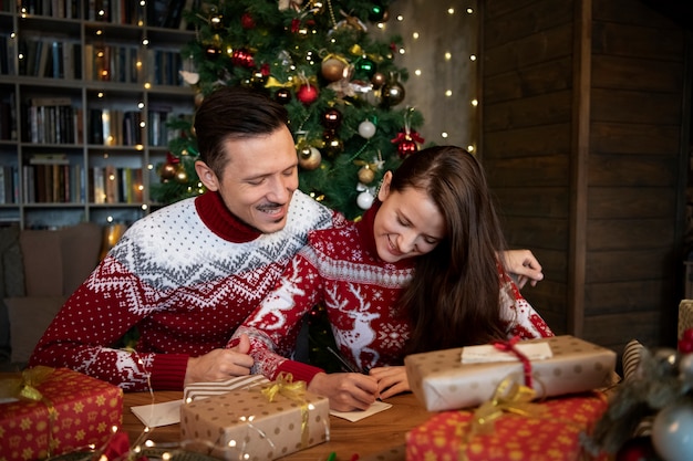 Couple giving each other christmas gifts