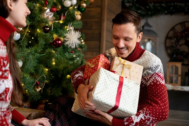 Couple giving each other christmas gifts