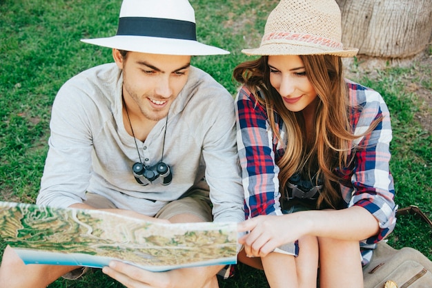 Couple of happy travelers on the grass