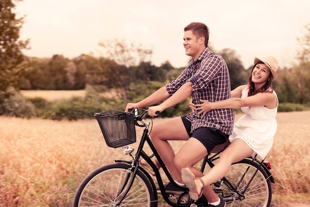 Couple have fun riding on bike