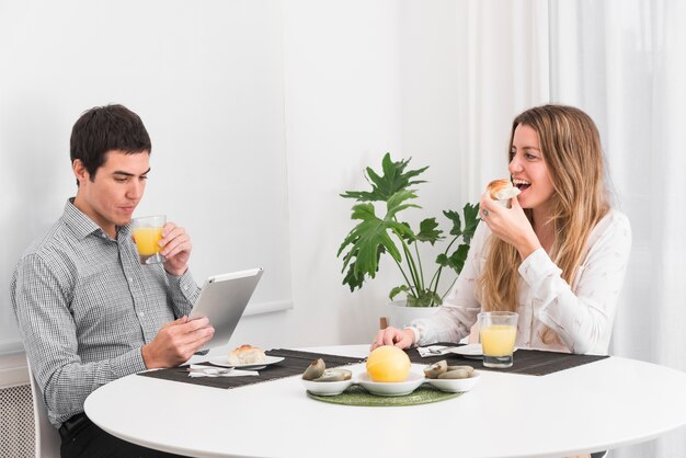 Couple having breakfast at table