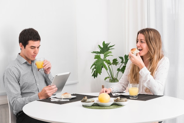 Couple having breakfast at table