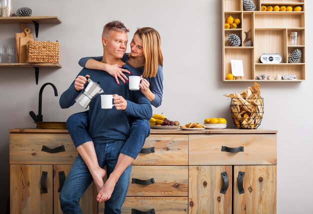 Couple having a fun time together in the kitchen