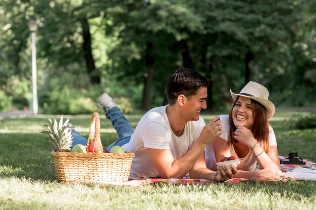 Couple having fun while lying on blanket