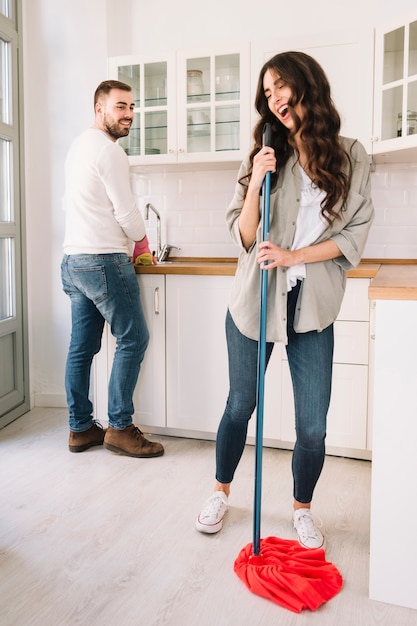 Free photo couple having fun while washing kitchen