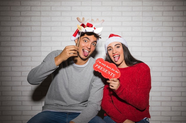 Couple having fun with Christmas decorations 