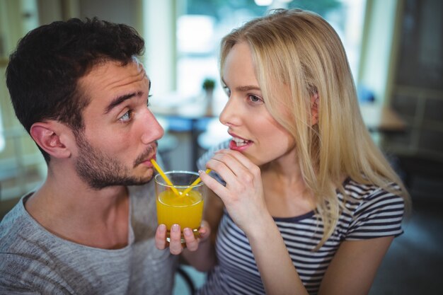 Free Photo couple having a glass of orange juice