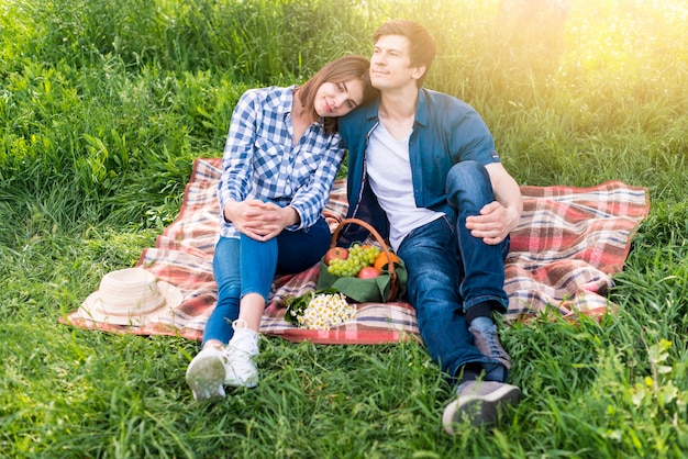 Free photo couple having great time at picnic on meadow