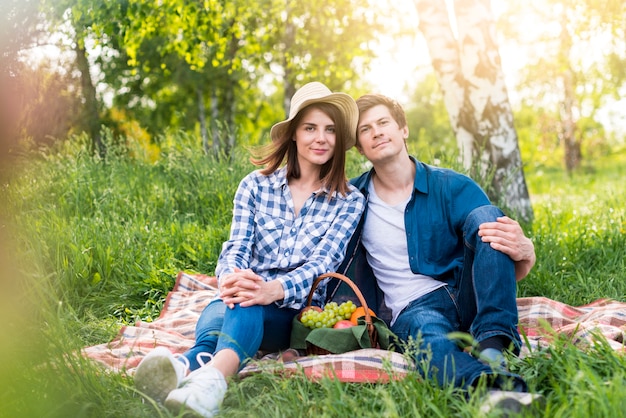 Couple having lovely picnic on glade