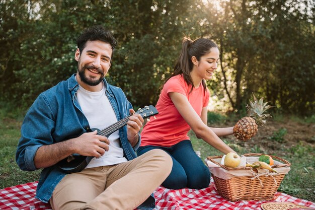 Couple having a picnic with guitar