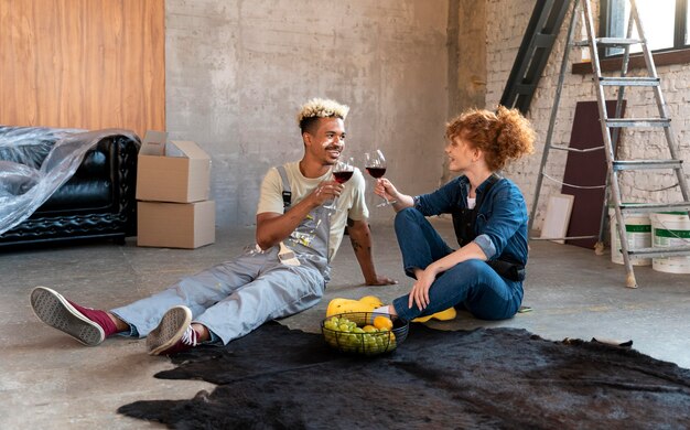 Couple having wine together after moving in their new home