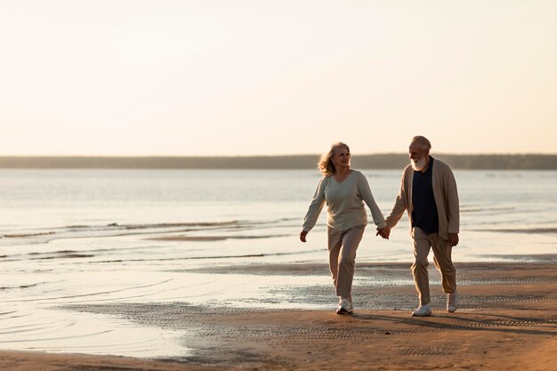 Couple holding hands at beach