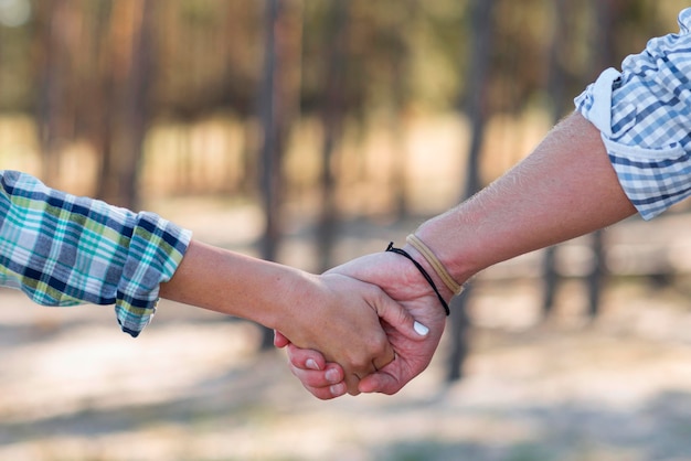 Couple holding hands blurred nature