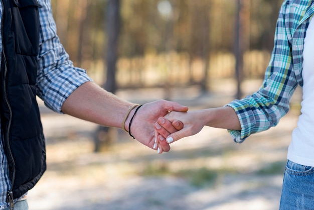 Free Photo couple holding hands front view