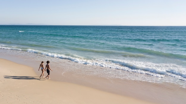 Couple holding hands and going to sea