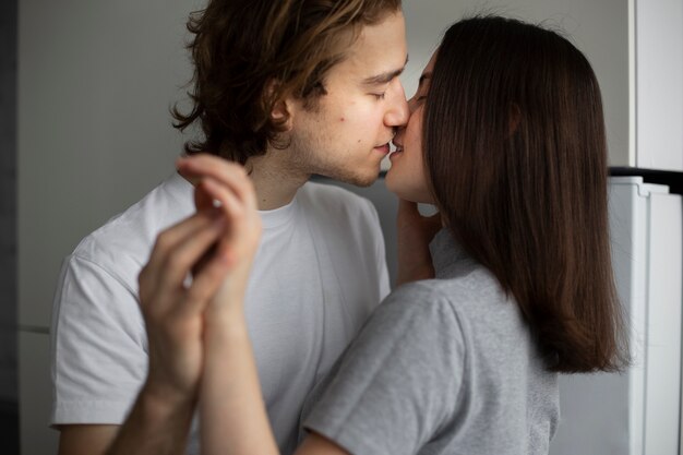 Couple holding hands while kissing