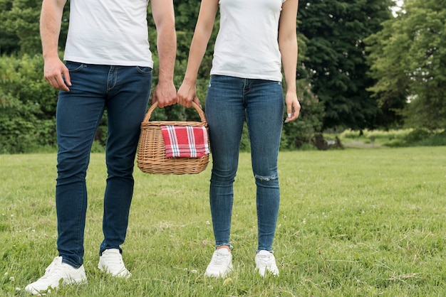 Couple holding a picnic basket