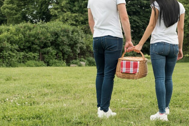 Couple holding a picnic basket