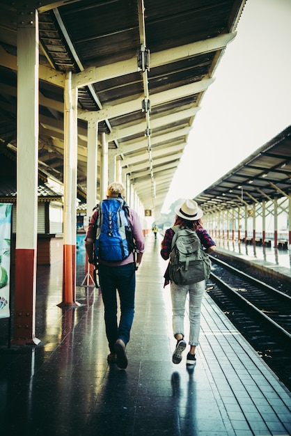 Couple holiday concept : Young hipster couple in train station.