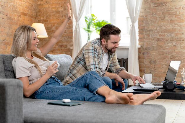 Couple at home having videocall with family