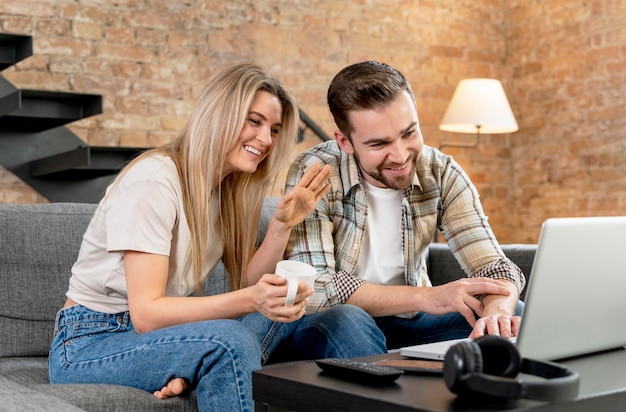 Couple at home having videocall with family