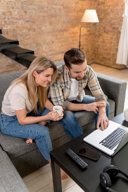 Couple at home having videocall with family