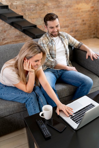 Couple at home having videocall with family