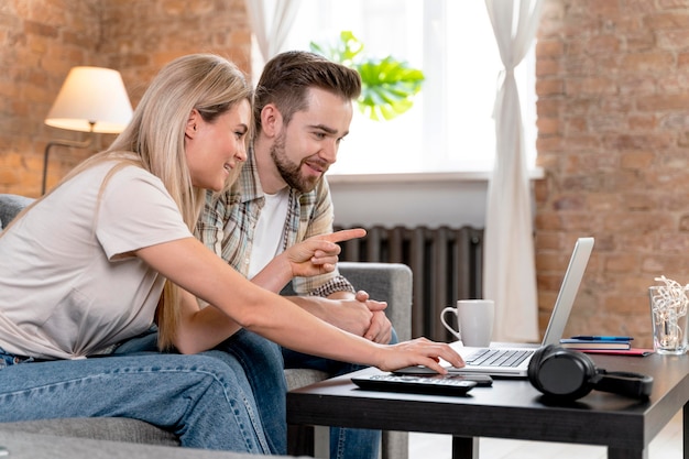 Couple at home having videocall with family