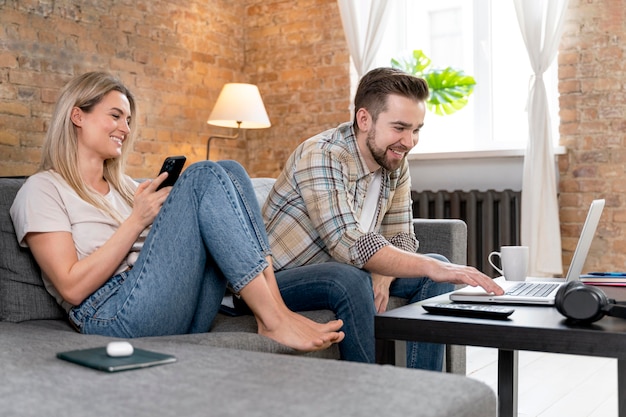 Couple at home having videocall with family