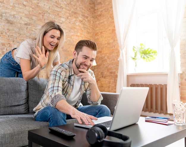 Couple at home having videocall with family