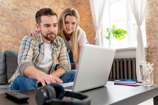 Couple at home having videocall with family